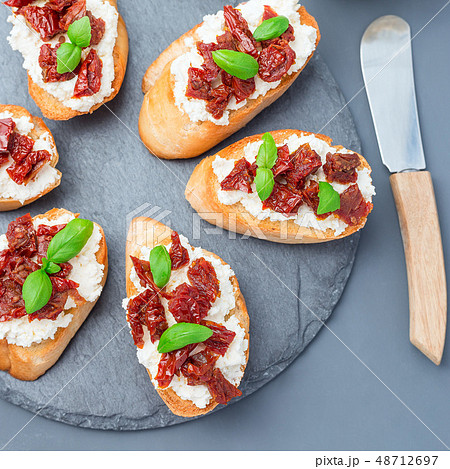Bruschetta with sun dried tomato, feta and basil 48712697