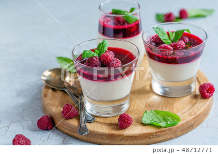 Vanilla Panna cotta with raspberry and mint. Vanilla Panna cotta with raspberry and mint. 48712771