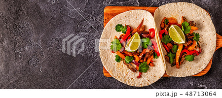 FAJITAS with colored pepper and onions, served 48713064