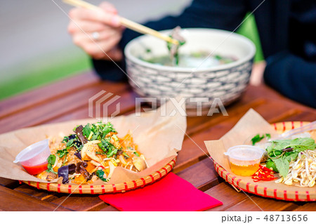 Asian rice noodles with vegetables and sause close-up on the table Asian rice noodles with vegetables and sause close-up on the table 48713656