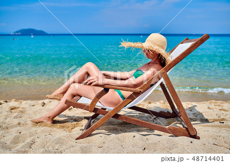 Woman in bikini on beach Woman in bikini on beach 48714401