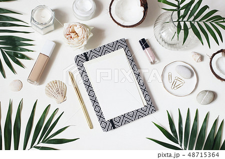 Lifestyle feminine desktop composition. Mockup of blank card. Notebook, skin cream, nail varnish and Lifestyle feminine desktop composition. Mockup of blank card. Notebook, skin cream, nail varnish and 48715364