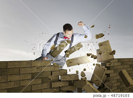 Businessman crashing bricks 48719103