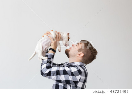 people, pets and animals concept - young man kissing jack russell terrier puppy on white background people, pets and animals concept - young man kissing jack russell terrier puppy on white background 48722495