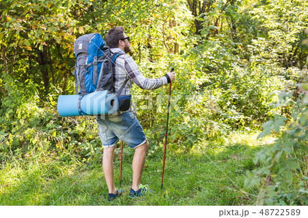 Travel, adventures, hike, tourism and nature concept - Tourist walking in the woods 48722589