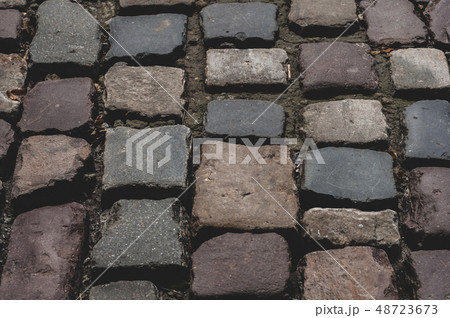 Pavement from a smooth textured old natural stone 48723673