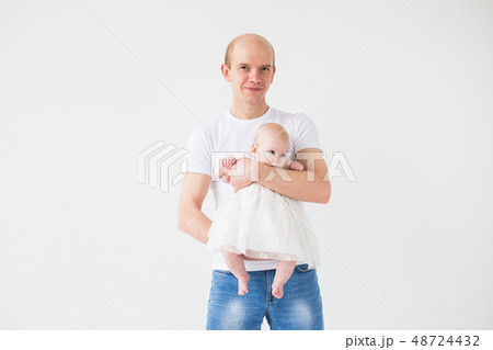 family, fatherhood and children concept - bald father holding cute newborn on white background with 48724432