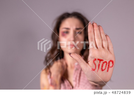 Domestic violence, protesting and people concept - brunette woman expressing denial with STOP on her Domestic violence, protesting and people concept - brunette woman expressing denial with STOP on her 48724839
