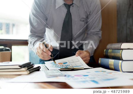 Casual businessman sitting at his desk online 48725989