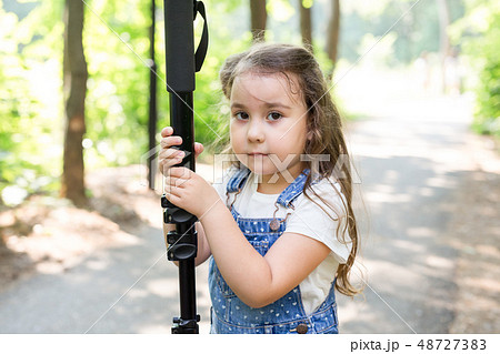 Hobby, profession, children and photographer concept - child with camera in forest Hobby, profession, children and photographer concept - child with camera in forest 48727383