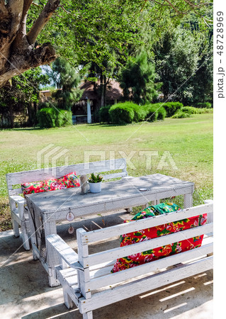 Image of Empty table in the house's garden. 48728969