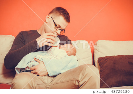 Father feeding from bottle newborn baby 48729180