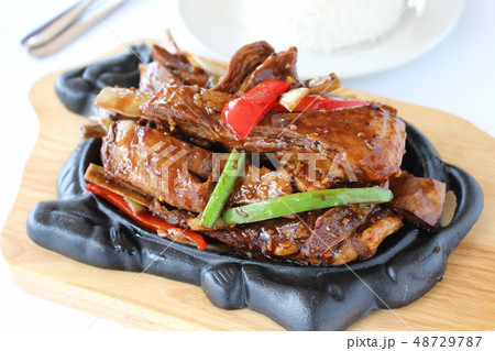Garlic and pepper pork on a hot plate Garlic and pepper pork on a hot plate 48729787