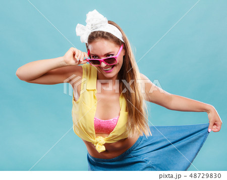 Portrait of happy pin up girl wearing sunglasses. 48729830
