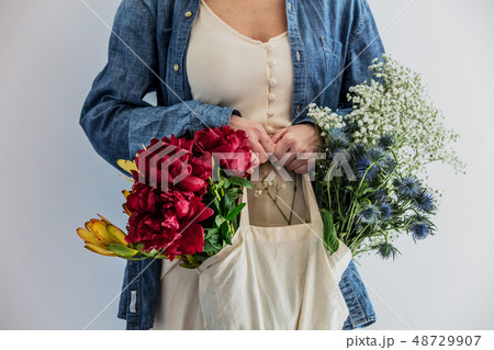 Female hands holding bouquet of peonies, babys breathand and Leucadendron Female hands holding bouquet of peonies, babys breathand and Leucadendron 48729907