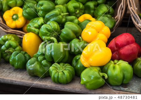 Green, red and yellow bell peppers at the market 48730481