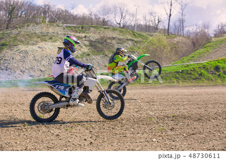 competition between two motocross bikes, side view 48730611