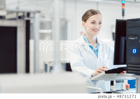 Engineer operating manufacturing line in electronics factory 48731271