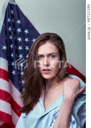 Portrait of beautiful woman against the background of the American flag 48731389