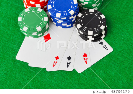 Casino chips and playing cards on green table Casino chips and playing cards on green table 48734179