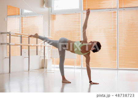 Young woman doing yoga on floor Young woman doing yoga on floor 48738723