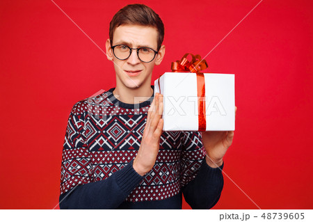 Curious man with glasses, a man holding a gift box 48739605