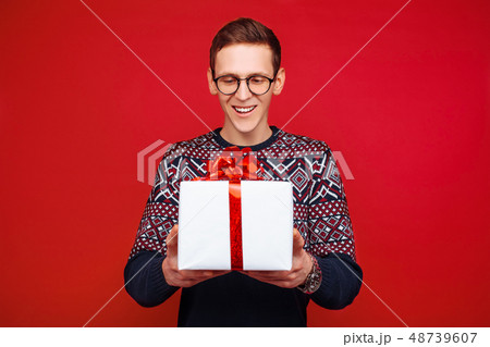 Portrait of a man with glasses, with a gift box 48739607