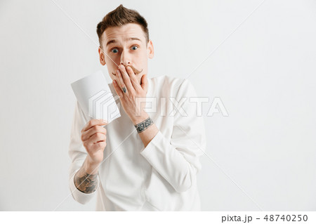Young man with a surprised expression won a bet 48740250