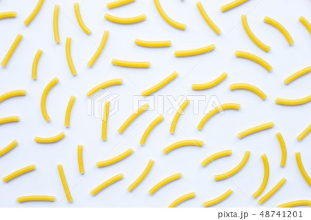 Uncooked macaroni on a white white 48741201