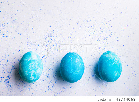 Painted eggs flat lay on a white background. Easter and spring composition. Copy space. Painted eggs flat lay on a white background. Easter and spring composition. Copy space. 48744068