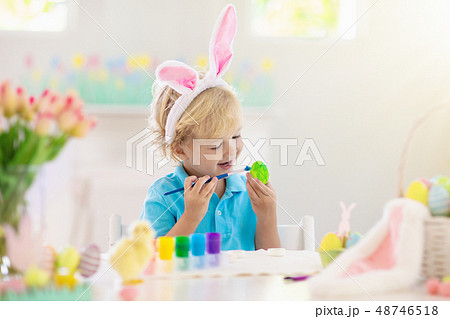 Kids on Easter egg hunt. Children dye eggs. 48746518