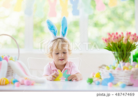 Kids on Easter egg hunt. Children dye eggs. Kids on Easter egg hunt. Children dye eggs. 48747469