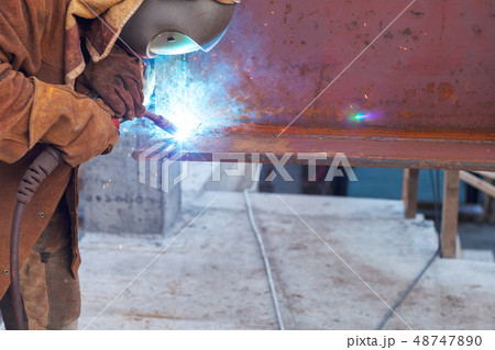 Worker welding in a factory. Welding on an industrial plant Worker welding in a factory. Welding on an industrial plant 48747890