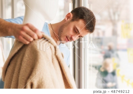 Young man dress on mannequin in clothing store. 48749212