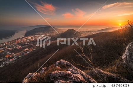 View of a Small City near a River at Sunrise 48749333