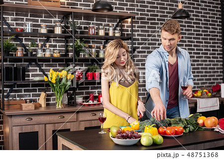 Caring loving man helping his girlfriend cooking dinner in the kitchen 48751368