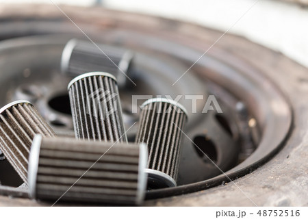 Old lubricant engine oil filter at car garage 48752516
