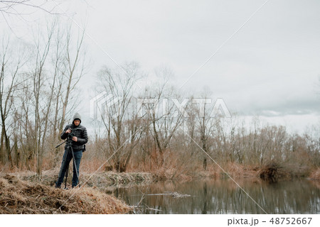 Camerman standing with camera 48752667