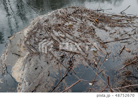 Garbage floating in water 48752670