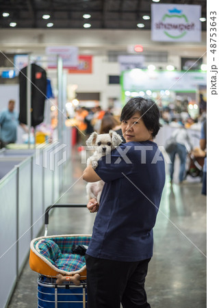 Asian woman and the dog in exhibit hall or expo Asian woman and the dog in exhibit hall or expo 48753643