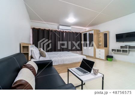 Luxury Interior bedroom with leather sofa of living room, Studio room type of condominium or apartment, service apartment and Accommodations Concept 48756575