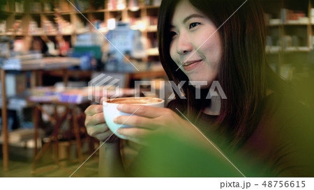 Portrait of asian businesswoman in casual suit drinking in happiness action in modern coffee shop and library, lifestyle concept Portrait of asian businesswoman in casual suit drinking in happiness action in modern coffee shop and library, lifestyle concept 48756615