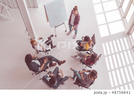Top view of creative manager presenting the creative ideas in front of Group Of Asian Business people with casual suit in happy action in the modern workplace Top view of creative manager presenting the creative ideas in front of Group Of Asian Business people with casual suit in happy action in the modern workplace 48756641