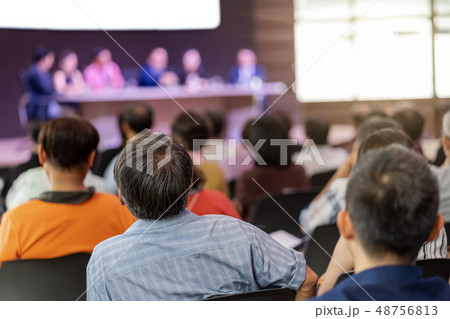 Rear view of Audience in the conference hall or seminar meeting which have Speakers are Brainstorming and talking on the stage, business and education about investment concept 48756813