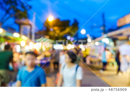 Group of blurred people shopping in outdoor market 48756909