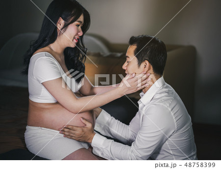Pregnant women with husband feeling happy 48758399
