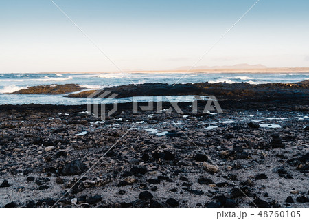 Scenic view of rocky beach at sunset Scenic view of rocky beach at sunset 48760105