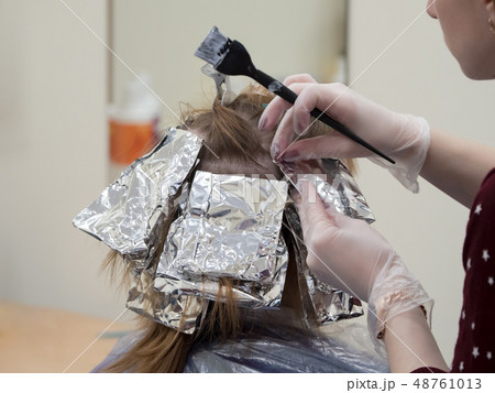 Foil on the hair when coloring the hair. 48761013
