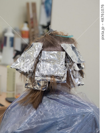 Foil on the hair when coloring the hair. Foil on the hair when coloring the hair. 48761076