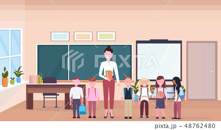 woman teacher with mix race pupils standing in modern school classroom interior chalk board desk woman teacher with mix race pupils standing in modern school classroom interior chalk board desk 48762480